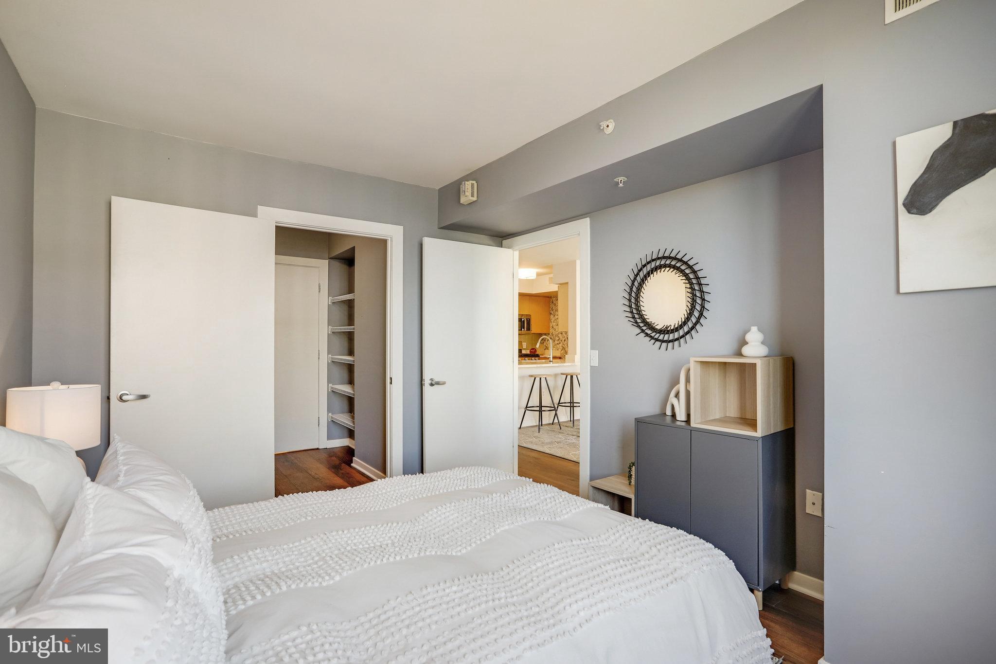 1000 New Jersey Avenue Southeast, Unit 914 Washington, DC 20003 - Photo 24 of 48 a bedroom with a bed and a chandelier