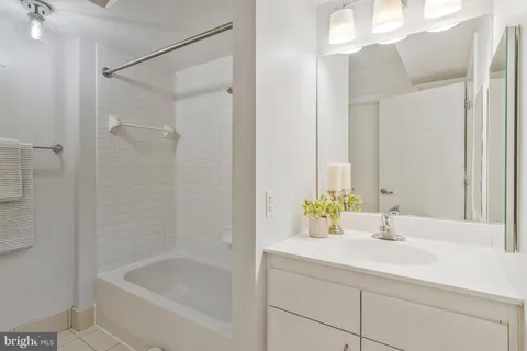 a bathroom with a sink and a bathtub with shower