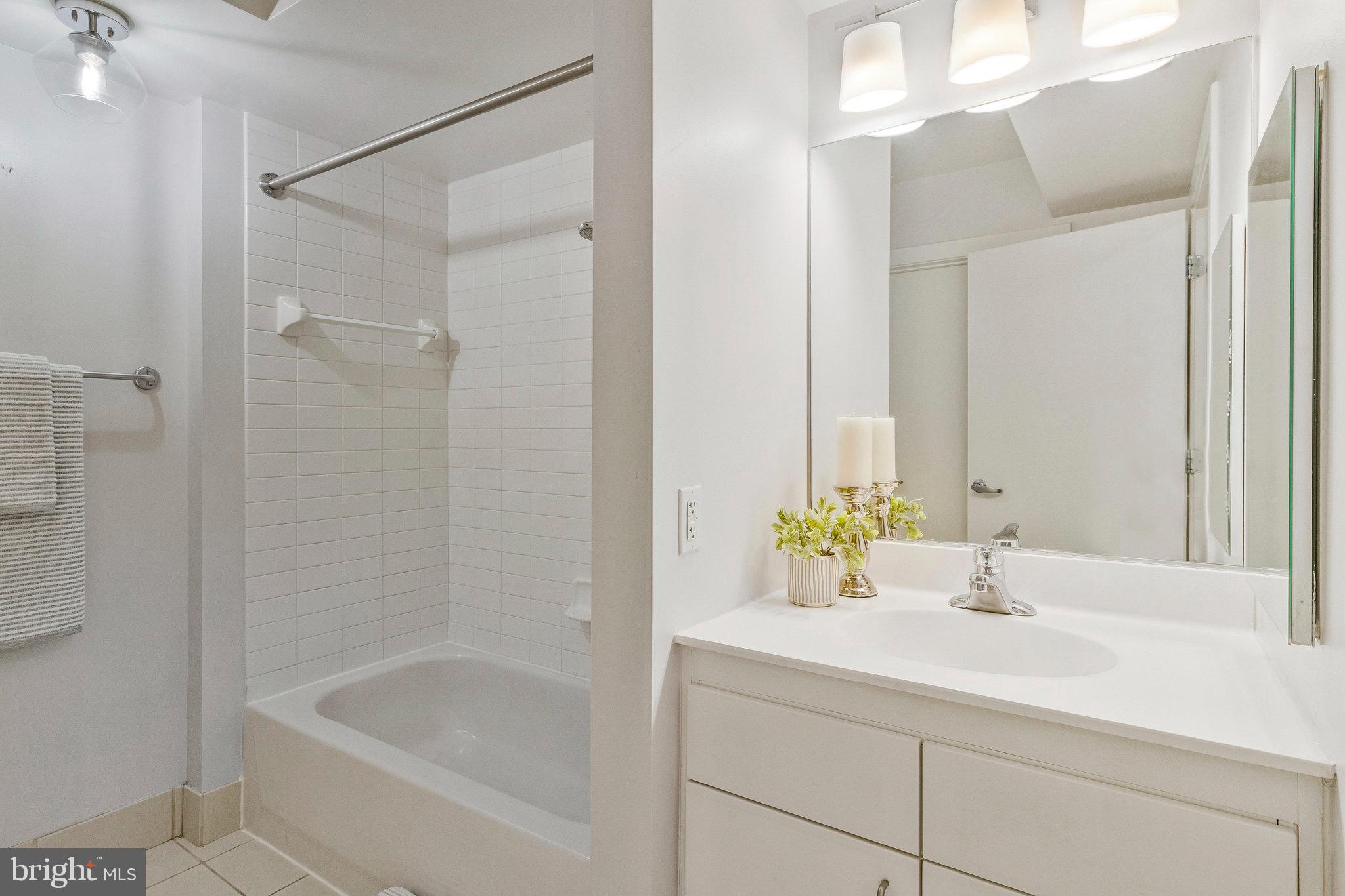 1000 New Jersey Avenue Southeast, Unit 914 Washington, DC 20003 - Photo 27 of 48 a bathroom with a sink and a bathtub with shower