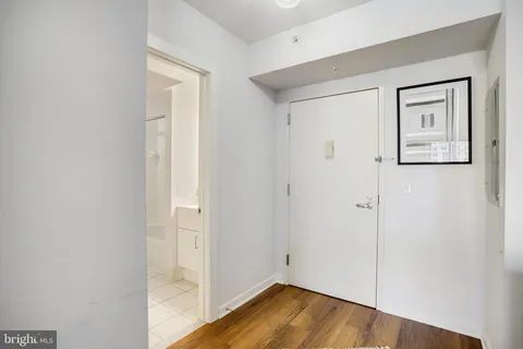 a view of a hallway with wooden floor
