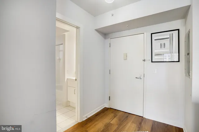 a view of a hallway with wooden floor