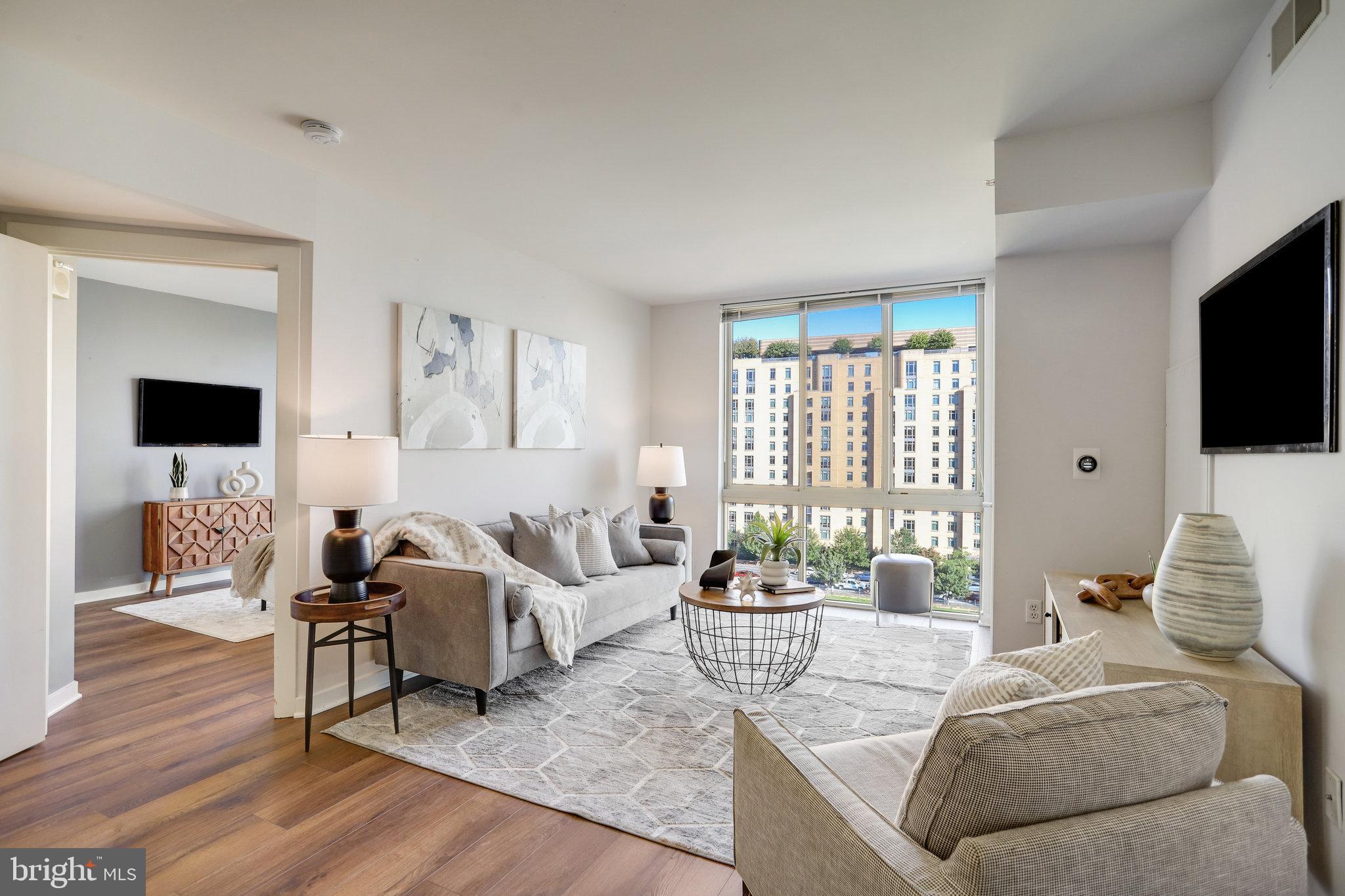 1000 New Jersey Avenue Southeast, Unit 914 Washington, DC 20003 - Photo 4 of 48 a living room with furniture and a flat screen tv
