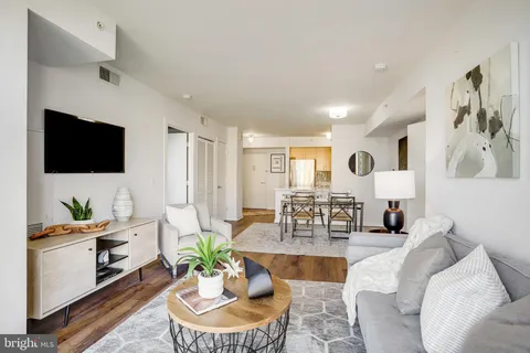 a living room with fireplace furniture and a flat screen tv