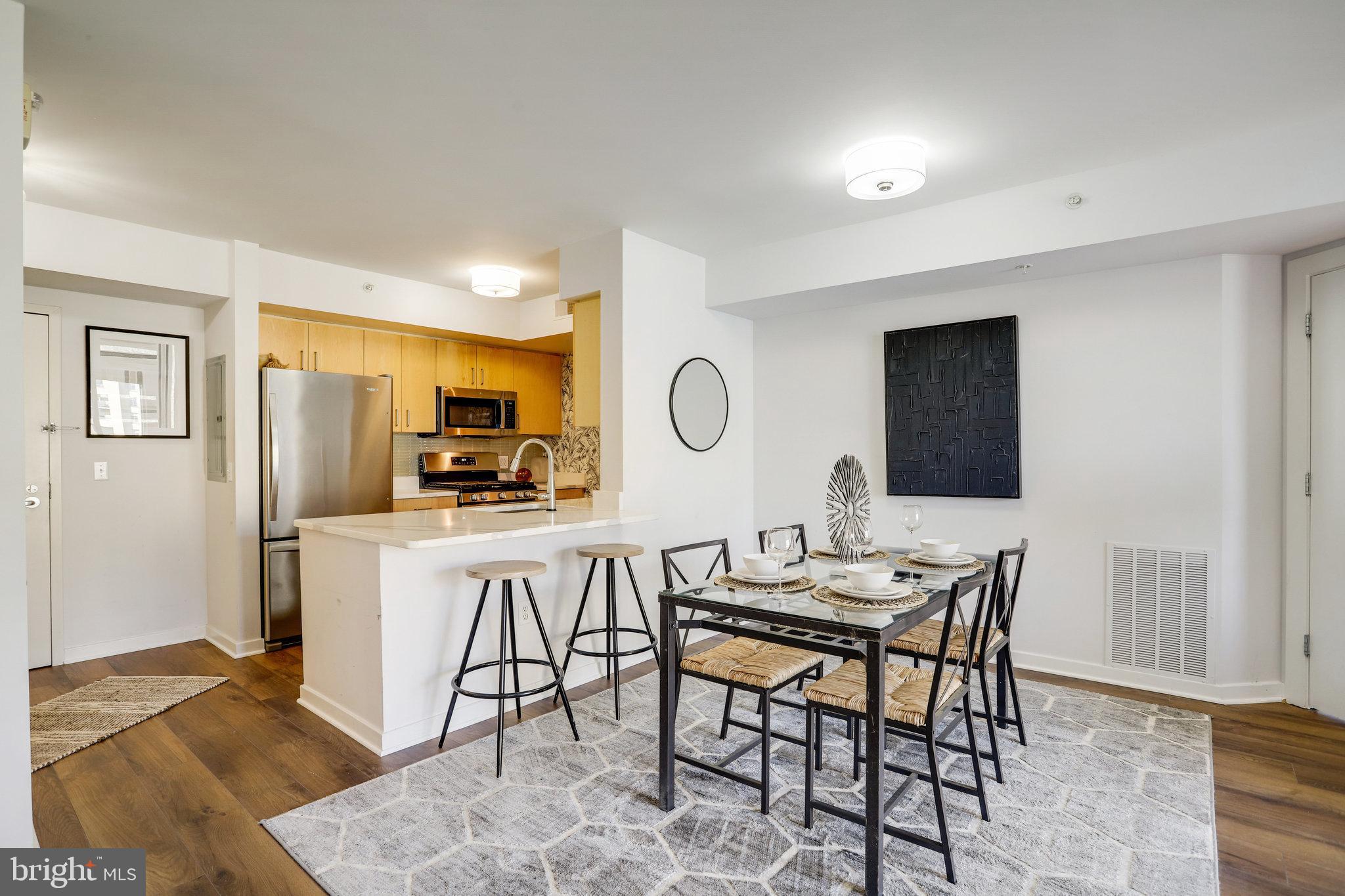 1000 New Jersey Avenue Southeast, Unit 914 Washington, DC 20003 - Photo 8 of 48 a view of a dining room with furniture