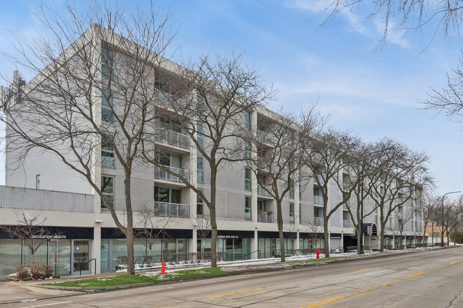 1625 Sheridan Road, Unit 204 Wilmette, IL 60091 - Photo 1 of 16 a view of a city street lined with buildings and trees