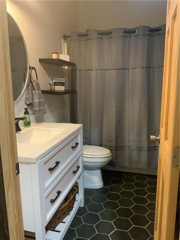 20 Moore Road West Alexander, PA 15376 - Photo 23 of 24 a bathroom with a sink a toilet a mirror and shower