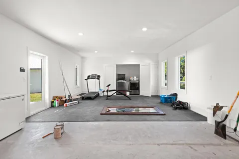 a room with gym equipment and a couch