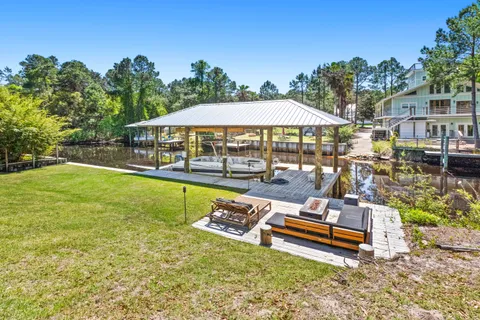a swimming pool with outdoor seating and yard