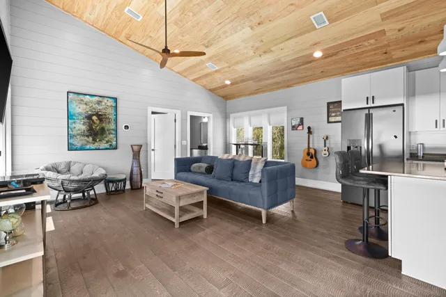 a living room with furniture kitchen and a table