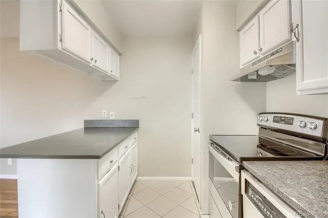 a kitchen with stainless steel appliances granite countertop a sink and a stove