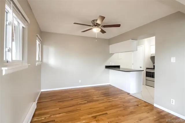a view of a kitchen with a sink and a refrigerator
