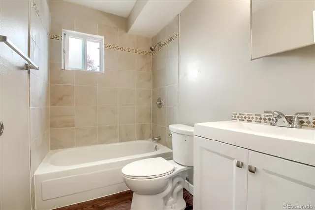 a bathroom with a sink a toilet and bathtub