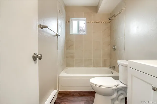 a bathroom with a toilet and a bath tub