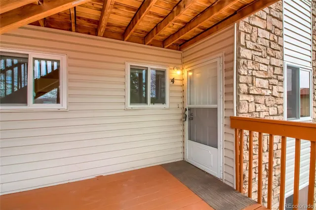 a view of a porch with wooden floor and fence