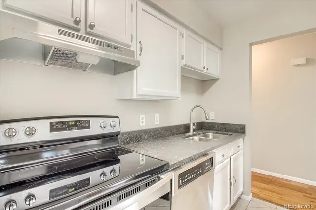 a kitchen with a stove and cabinets
