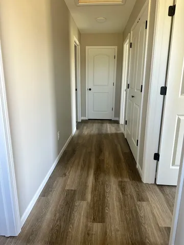 a view of a room with wooden floor