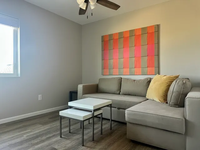 a living room with a couch and a window