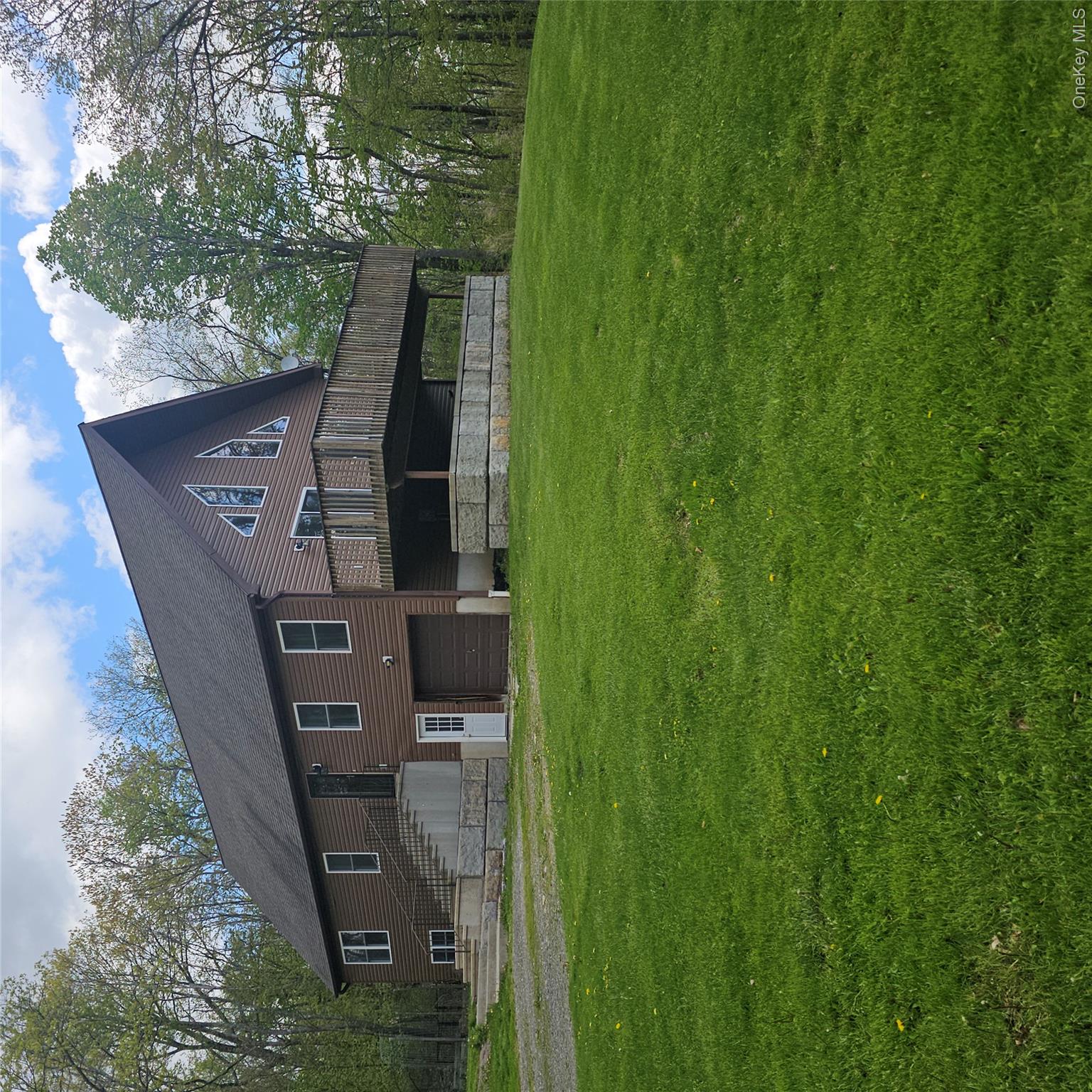 a front view of a house with a garden and deck