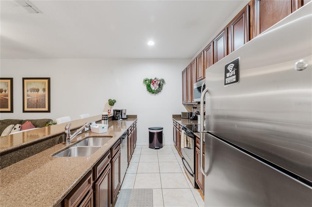 8961 Majesty Palm Road Kissimmee, FL 34747 - Photo 10 of 40 a kitchen with counter top space and stainless steel appliances