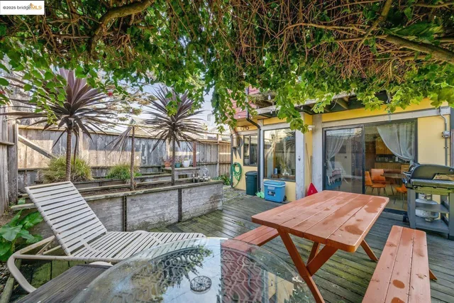 a view of a patio with couches table and chairs and potted plants