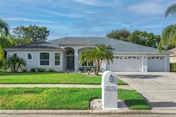 a front view of a house with a garden and plants