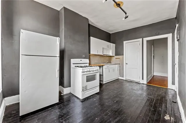 a kitchen with a refrigerator and a stove
