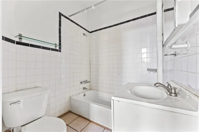 a bathroom with a sink a mirror toilet and bathtub