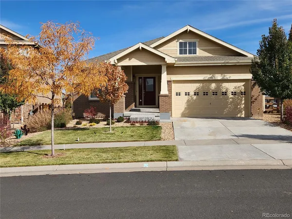 a front view of a house with a yard garage and outdoor seating