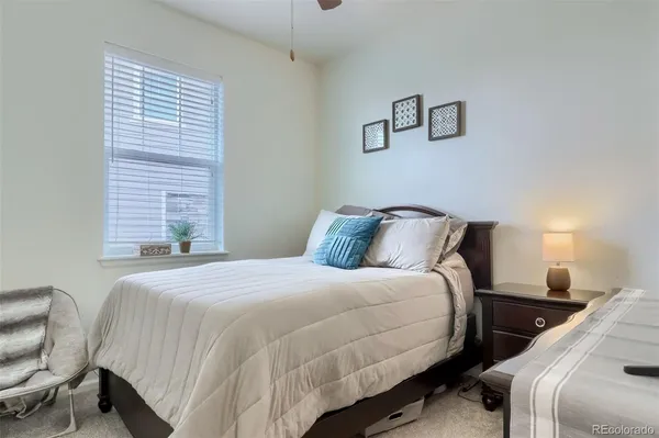 a bedroom with a bed and a chair