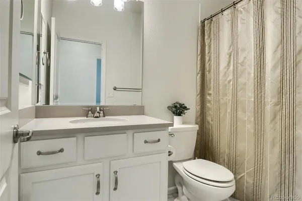 a bathroom with a toilet a sink and a mirror