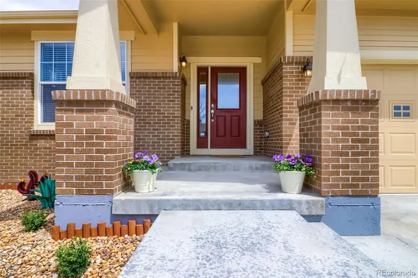 a view of a brick house with potted plants
