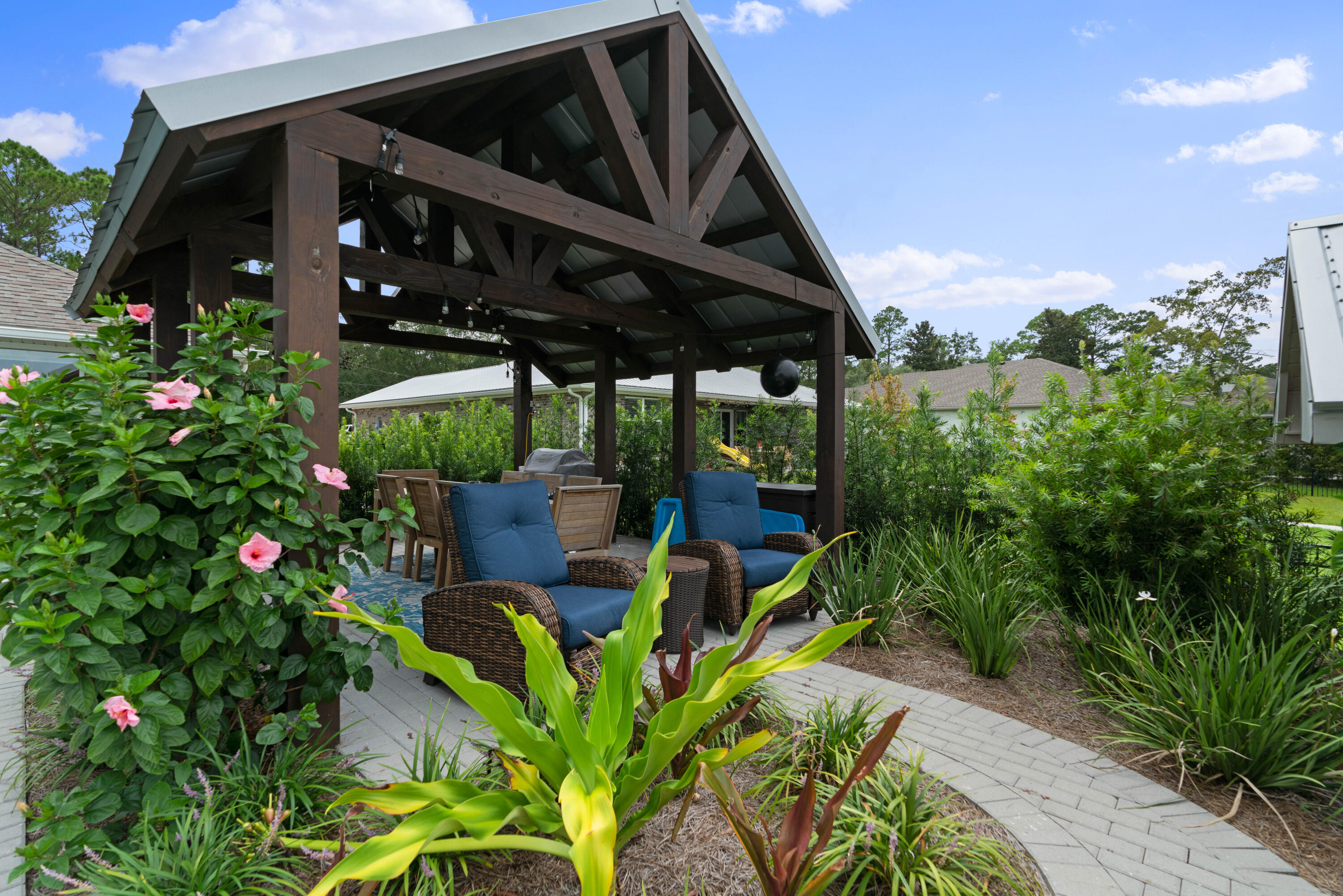 816 Bay Grove Road Freeport, FL 32439 - Photo 13 of 41 a view of a patio with table and chairs potted plants with wooden floor