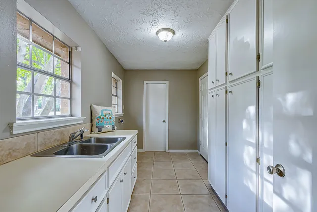 a kitchen that has a sink a window and stainless steel appliances