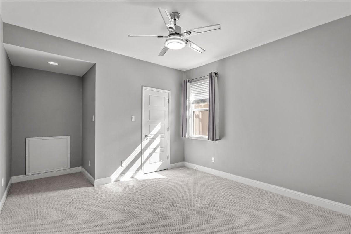 4108 Bison Bend, Unit FOR RENT Cedar Park, TX 78613 - Photo 30 of 36 Bedroom 4 upstairs. A well-lit bedroom with fresh carpeting, a modern ceiling fan, and a single window offering natural light.