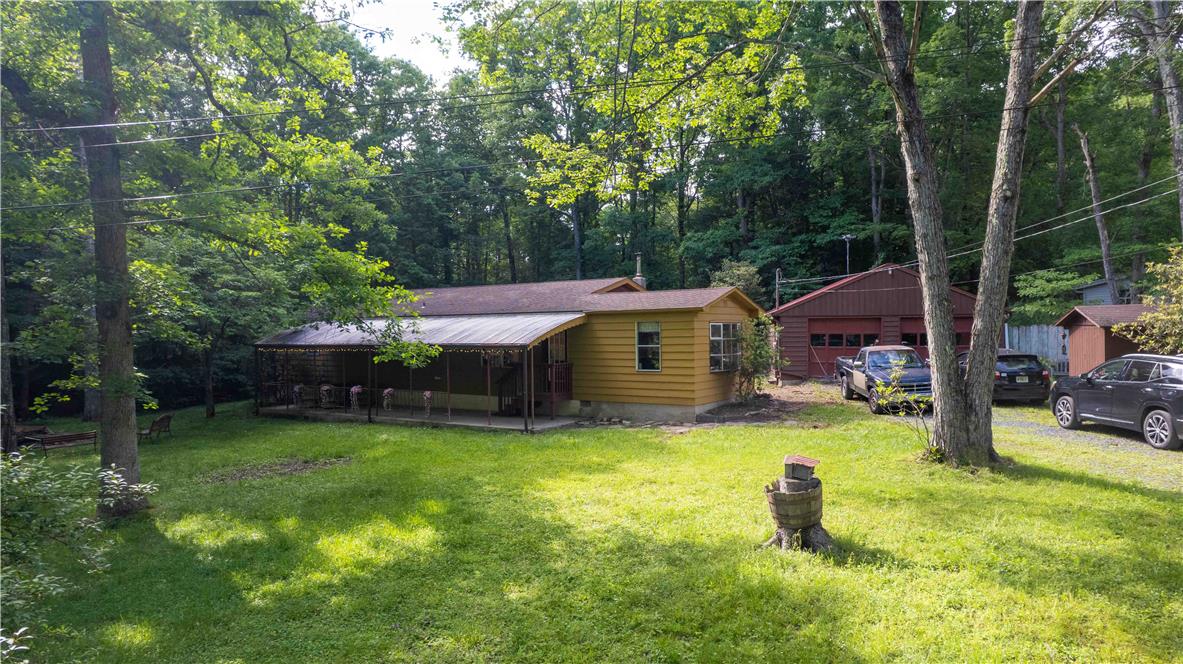 8 Cross Rds Drive Jim Thorpe, PA 18229 - Photo 28 of 32 A tranquil woodland retreat with a spacious yard and inviting covered porch.