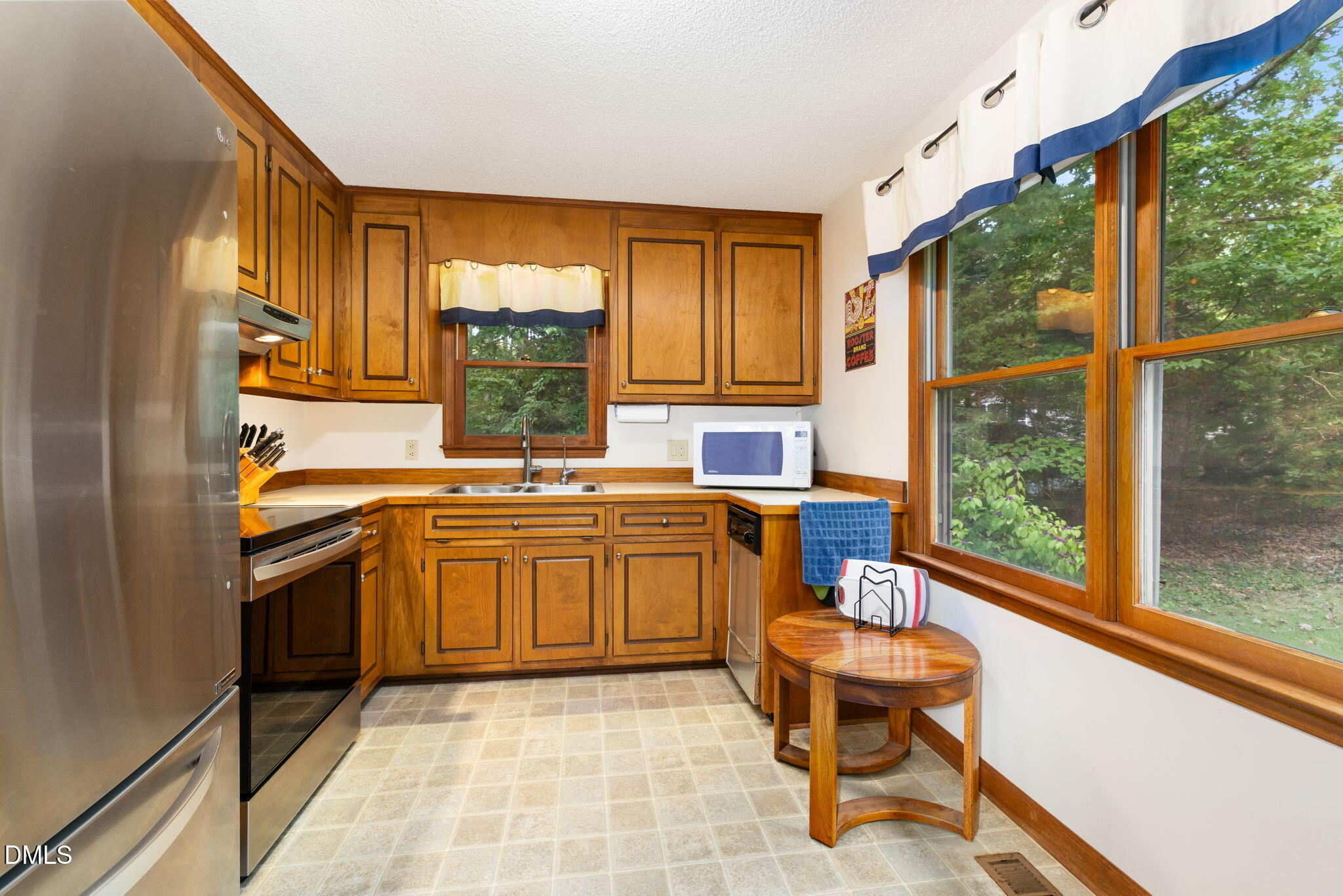 1873 Mill Creek Road Clarksville, VA 23927 - Photo 30 of 50 a kitchen with a sink and wooden cabinets