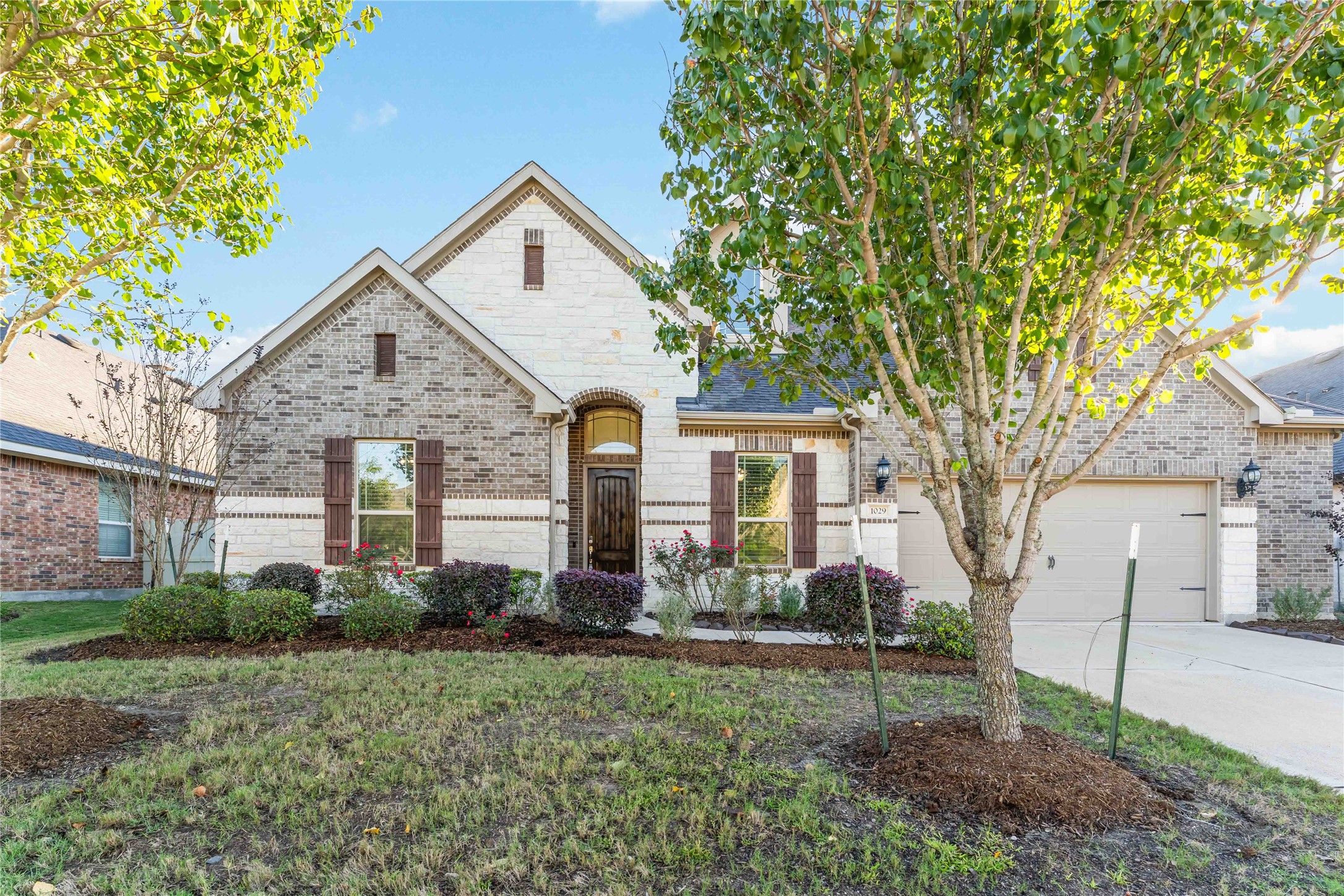a front view of house with yard and green space