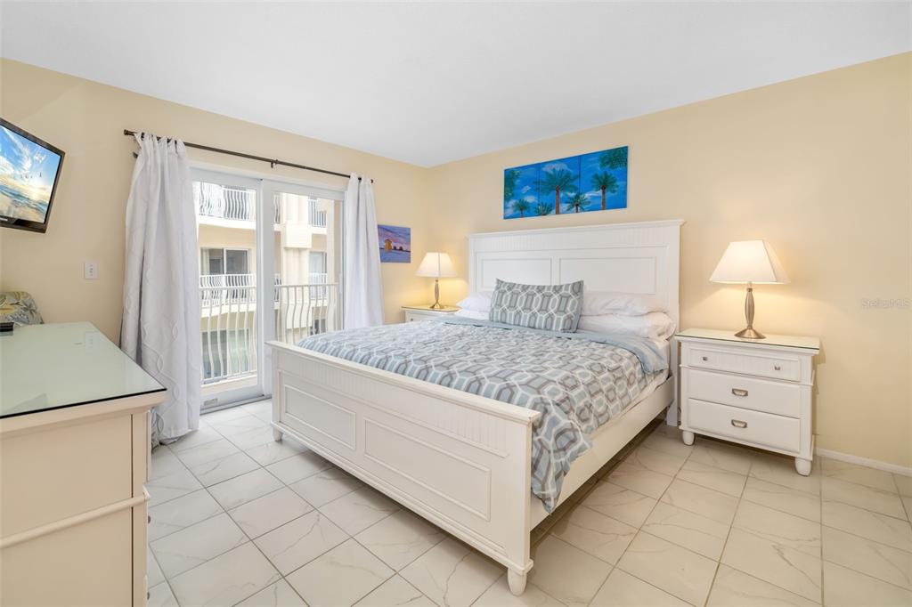 5961 Midnight Pass Road, Unit 319 Sarasota, FL 34242 - Photo 12 of 34 a bedroom with a bed and a cabinets