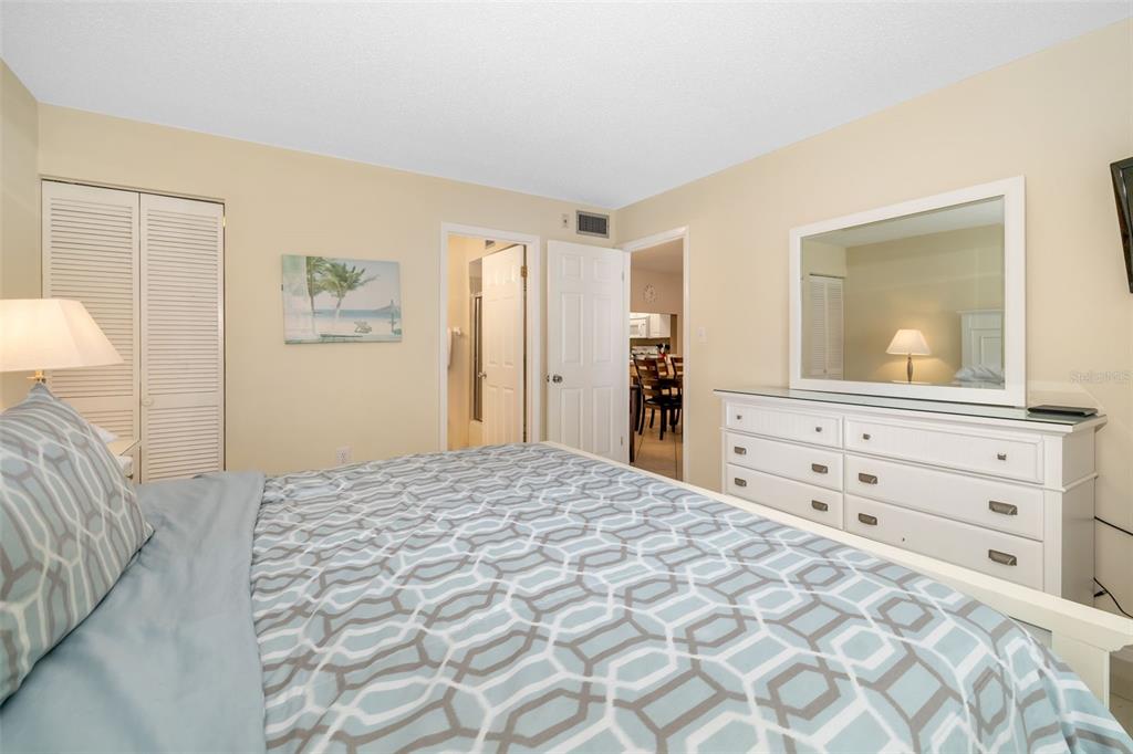 5961 Midnight Pass Road, Unit 319 Sarasota, FL 34242 - Photo 14 of 34 a bedroom with a bed and a dresser in it