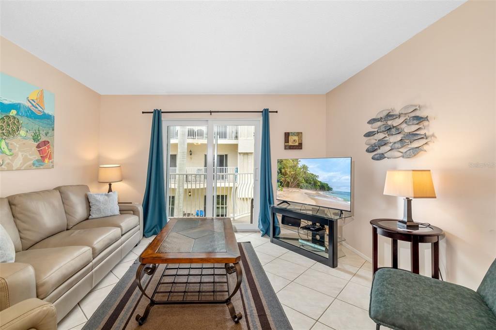 5961 Midnight Pass Road, Unit 319 Sarasota, FL 34242 - Photo 15 of 34 a living room with furniture and a table