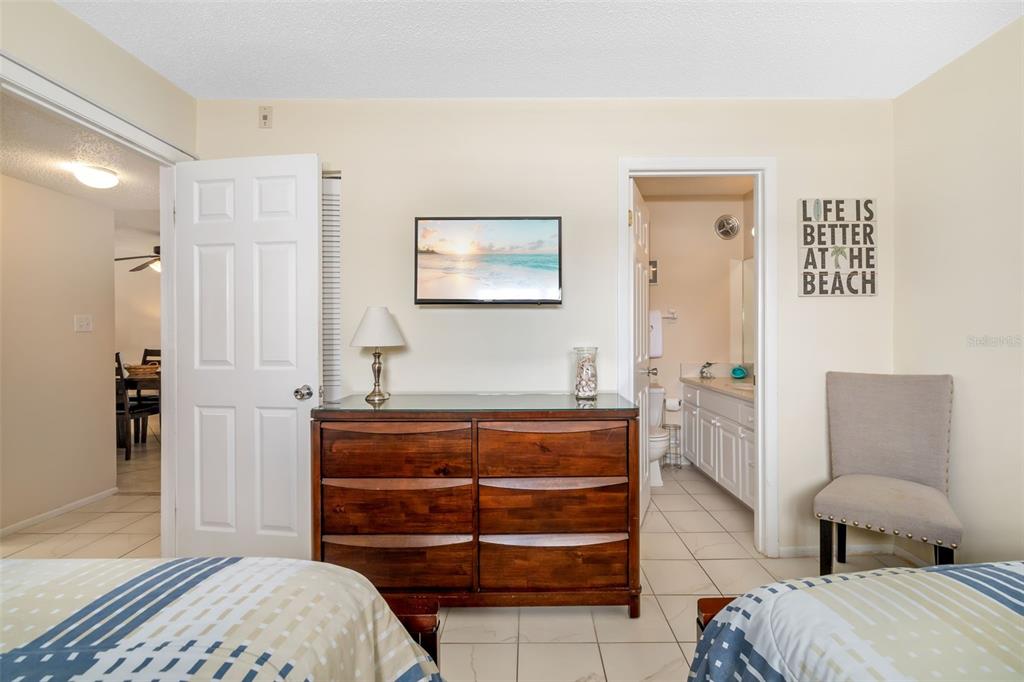 5961 Midnight Pass Road, Unit 319 Sarasota, FL 34242 - Photo 17 of 34 a bedroom with a bed and a couch