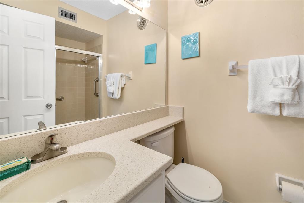 5961 Midnight Pass Road, Unit 319 Sarasota, FL 34242 - Photo 19 of 34 a bathroom with a sink toilet and mirror