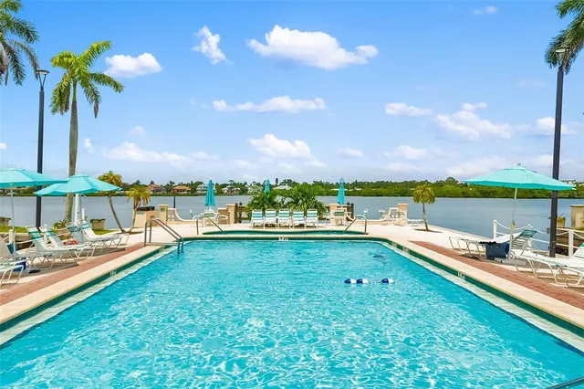 a view of a swimming pool and an outdoor seating