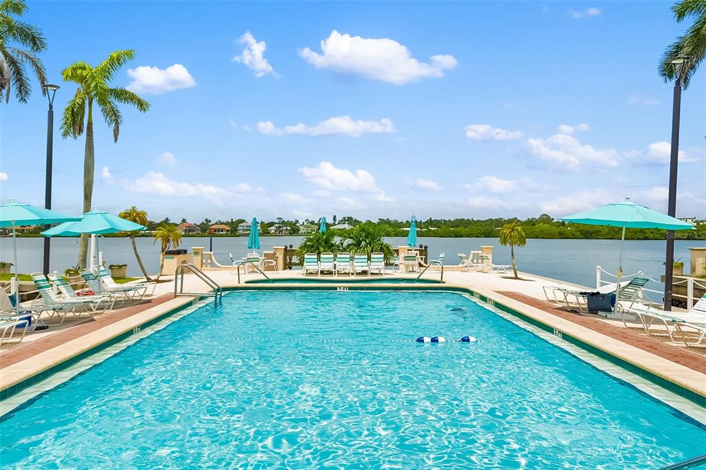 5961 Midnight Pass Road, Unit 319 Sarasota, FL 34242 - Photo 21 of 34 a view of a swimming pool and an outdoor seating