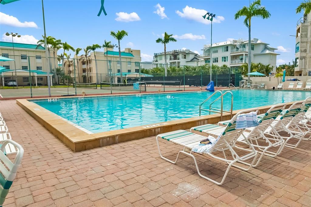 5961 Midnight Pass Road, Unit 319 Sarasota, FL 34242 - Photo 22 of 34 a view of a swimming pool with a patio