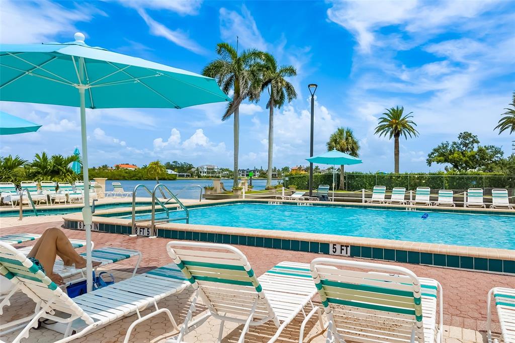5961 Midnight Pass Road, Unit 319 Sarasota, FL 34242 - Photo 23 of 34 a view of swimming pool with outdoor seating and city view