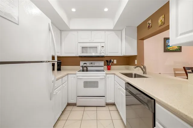 a kitchen with a sink cabinets and appliances