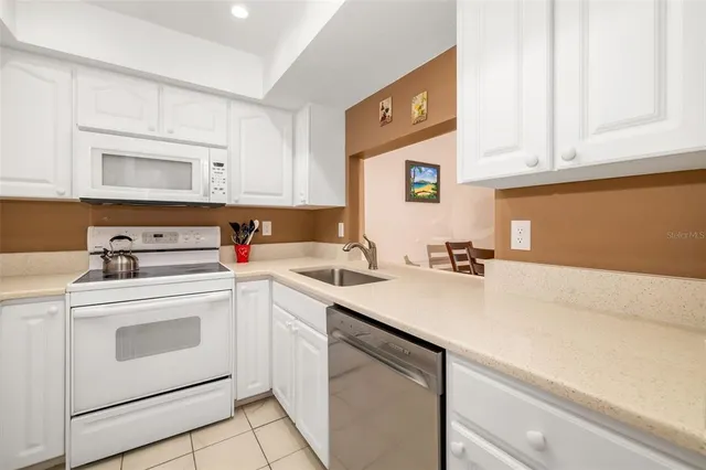a view of a kitchen with sink and cabinets