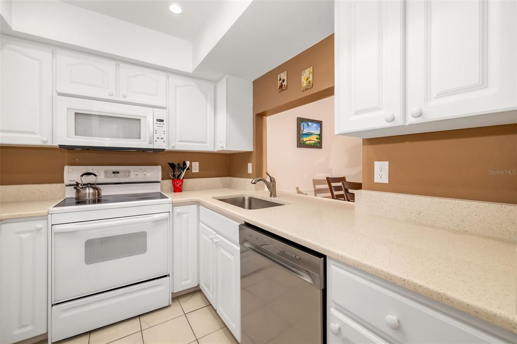5961 Midnight Pass Road, Unit 319 Sarasota, FL 34242 - Photo 6 of 34 a view of a kitchen with sink and cabinets