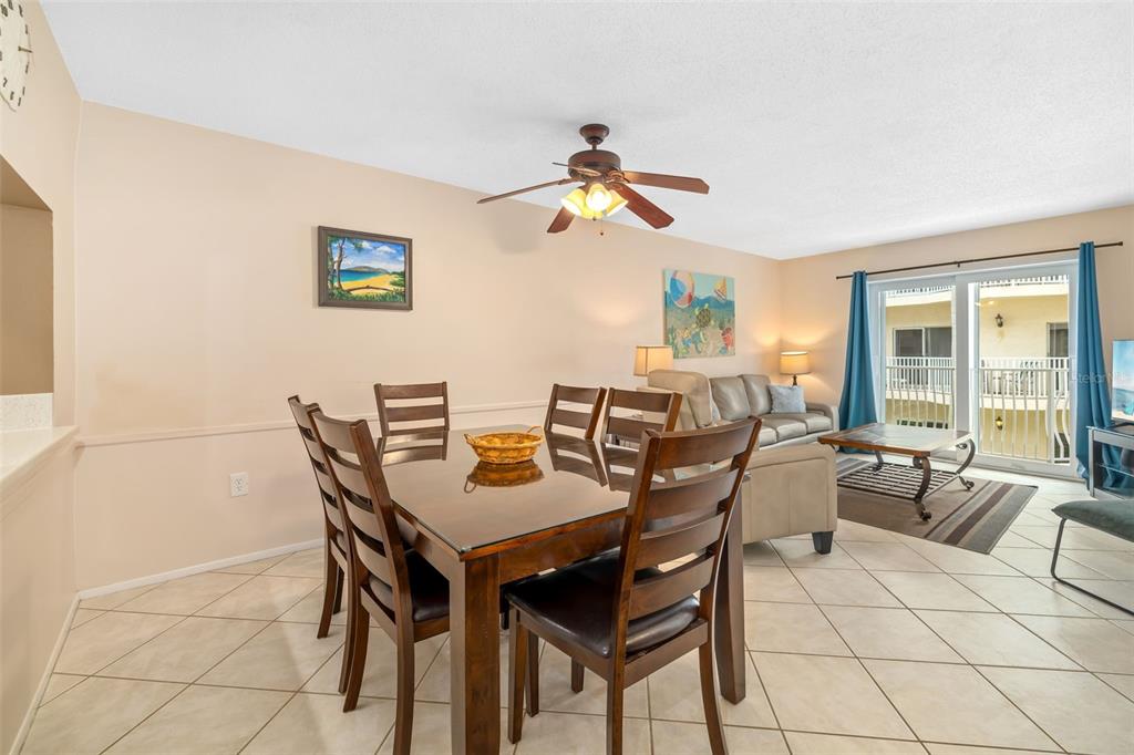 5961 Midnight Pass Road, Unit 319 Sarasota, FL 34242 - Photo 8 of 34 a view of a dining room with furniture and a potted plant